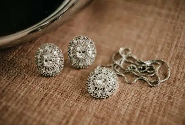 three pieces of jewelry sitting on top of a table